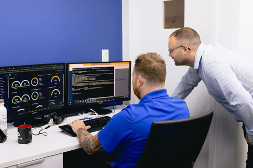 IT professionals working on network and cybersecurity monitoring.